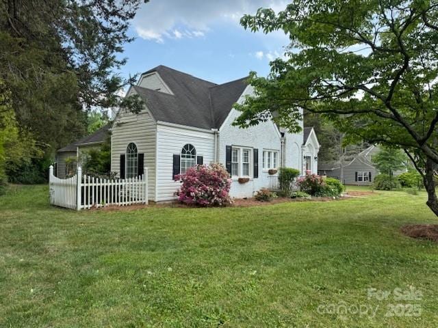 view of side of home featuring a lawn
