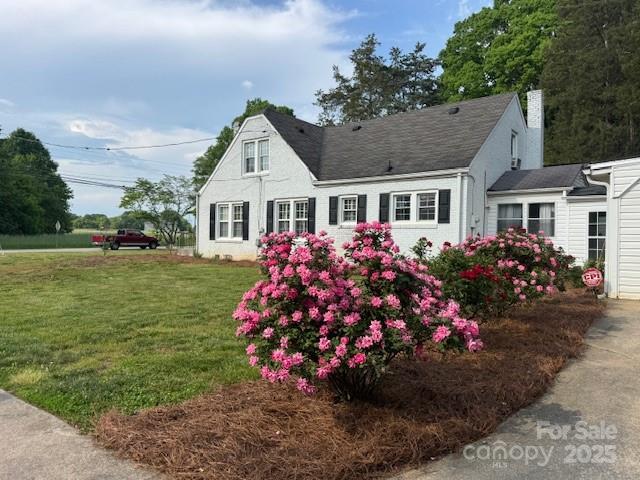 exterior space with a lawn and a chimney
