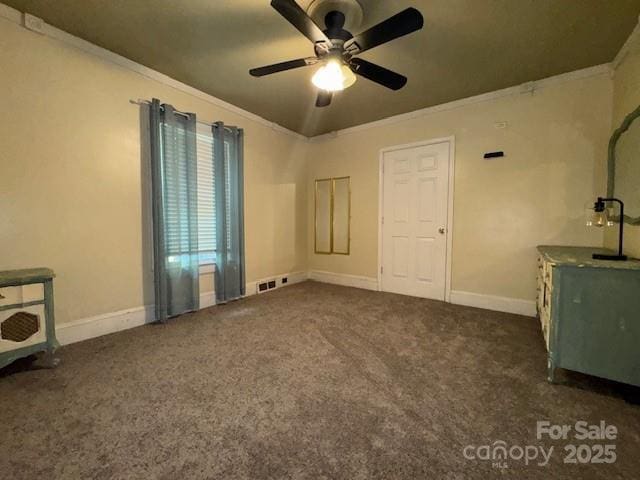 interior space featuring baseboards, a ceiling fan, carpet, and crown molding