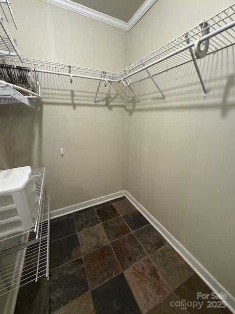 walk in closet with stone finish flooring