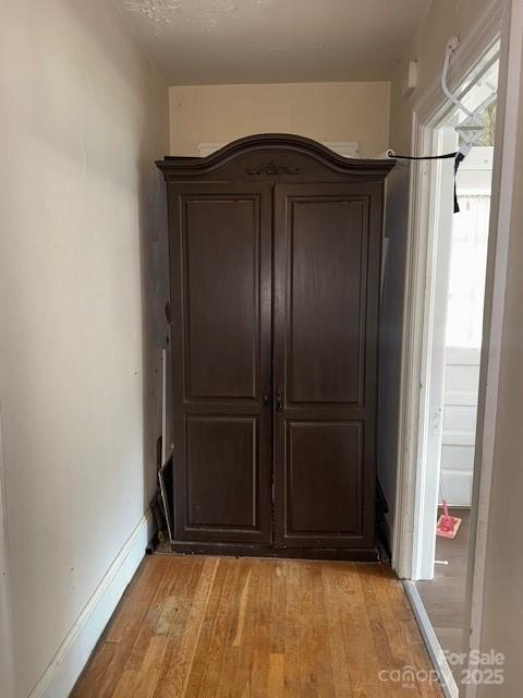 unfurnished bedroom with baseboards and light wood-style flooring