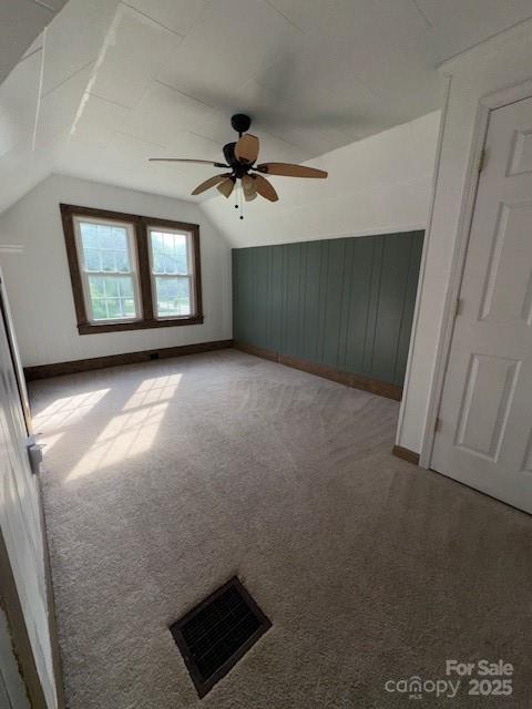 bonus room featuring carpet, a ceiling fan, baseboards, lofted ceiling, and visible vents