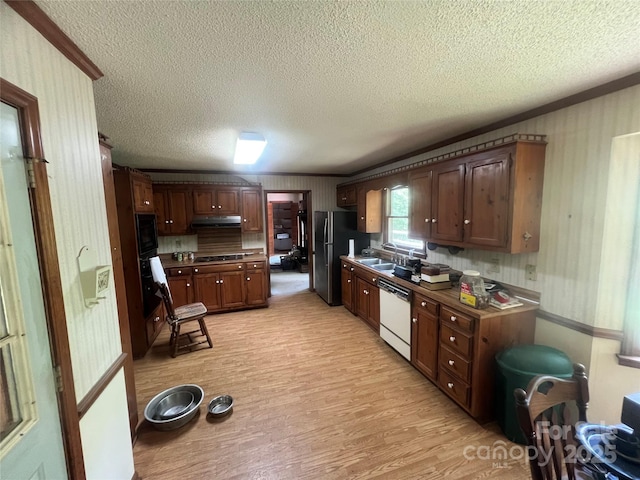 1502 Shelby Hwy, Cherryville, NC 28021 - kitchen with dishwasher, freestanding refrigerator, under cabinet range hood, a textured ceiling, and light wood-style floors