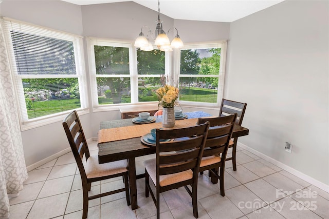 174 Perrin Dr, Mooresville, NC 28117 - dining area with a chandelier, light tile patterned floors, baseboards, and vaulted ceiling
