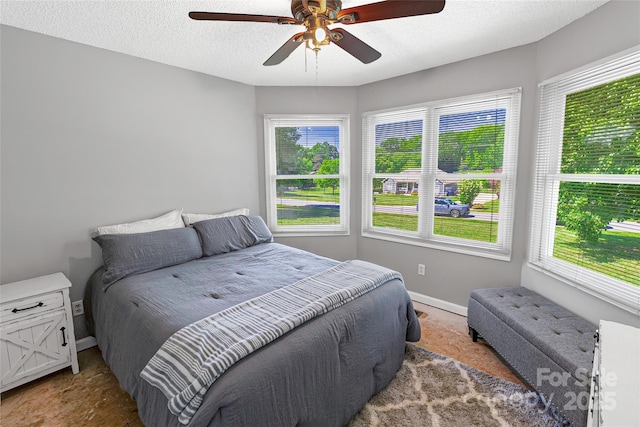 174 Perrin Dr, Mooresville, NC 28117 - carpeted bedroom with baseboards, ceiling fan, and a textured ceiling
