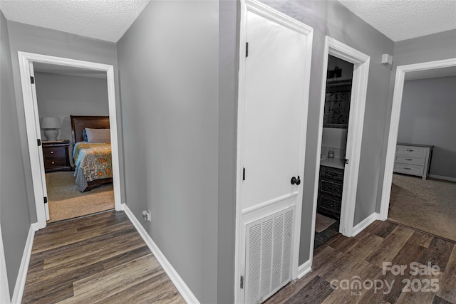 174 Perrin Dr, Mooresville, NC 28117 - hall featuring a textured ceiling, dark wood-style flooring, and baseboards