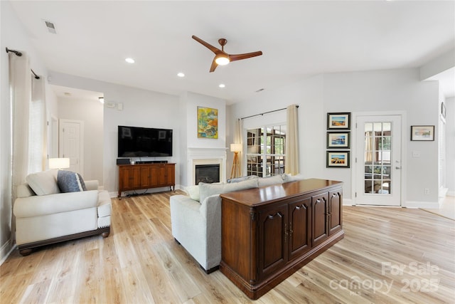 1728 Privette Rd, Matthews, NC 28105 - living room with a ceiling fan, light wood finished floors, a glass covered fireplace, baseboards, and recessed lighting