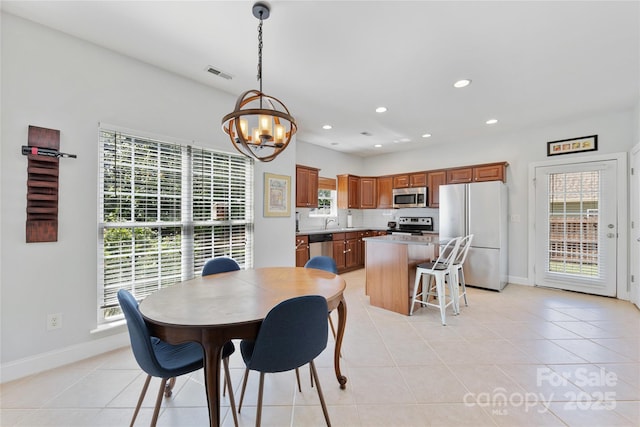 1728 Privette Rd, Matthews, NC 28105 - dining room featuring baseboards, a chandelier, light tile patterned flooring, healthy amount of natural light, and recessed lighting