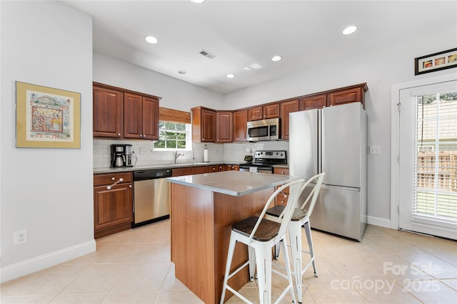 1728 Privette Rd, Matthews, NC 28105 - kitchen featuring appliances with stainless steel finishes, light tile patterned flooring, decorative backsplash, and recessed lighting