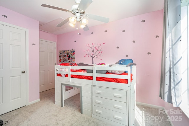 bedroom with baseboards, ceiling fan, and light carpet