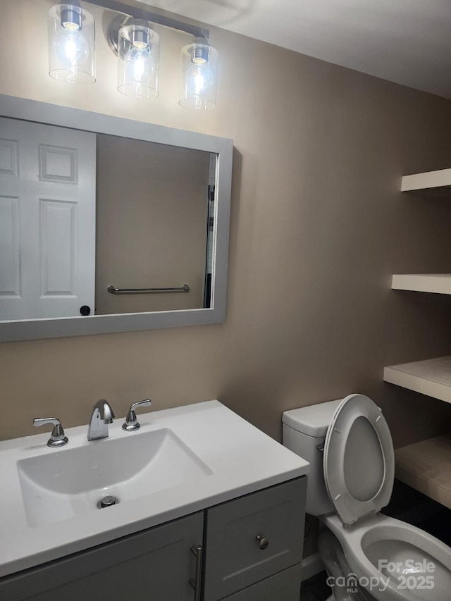 bathroom with toilet and vanity