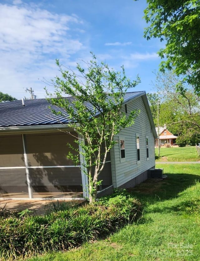 view of side of property with a yard