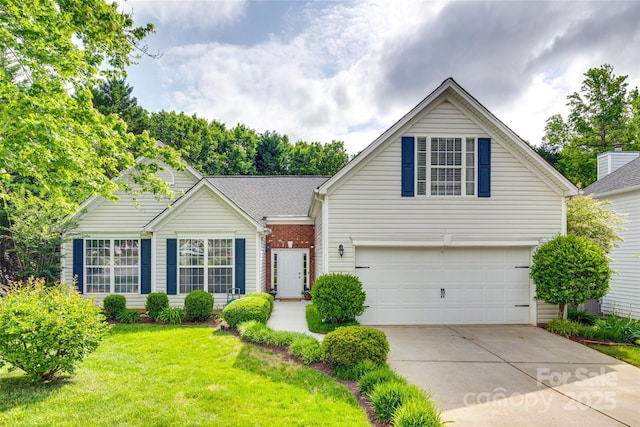 traditional home featuring a garage, concrete driveway, and a front lawn