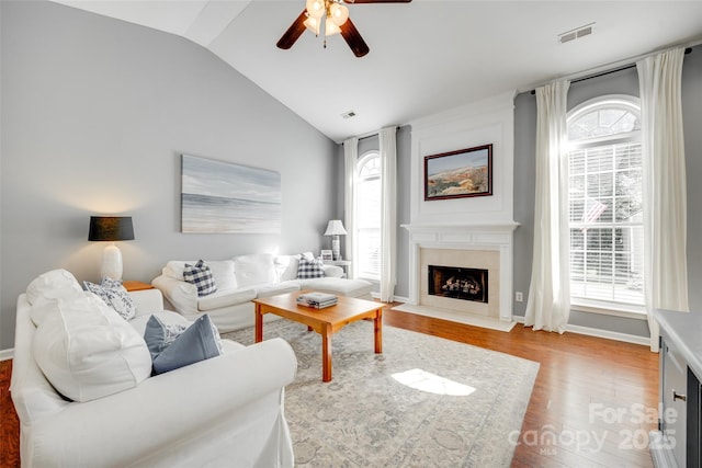 living room with visible vents, ceiling fan, wood finished floors, and a healthy amount of sunlight
