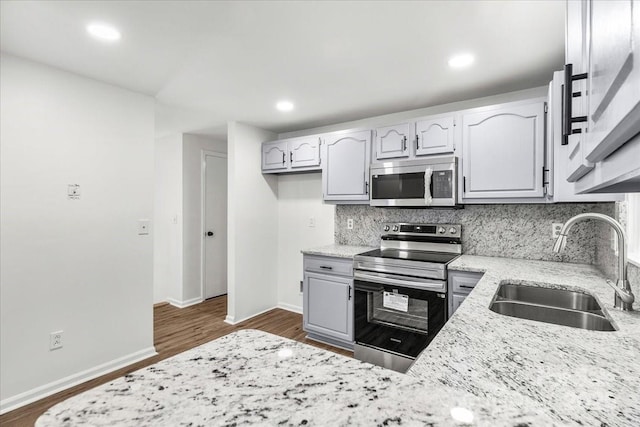 6839 Wagon Oak Rd, Charlotte, NC 28212 - kitchen with light stone countertops, baseboards, a sink, tasteful backsplash, and appliances with stainless steel finishes
