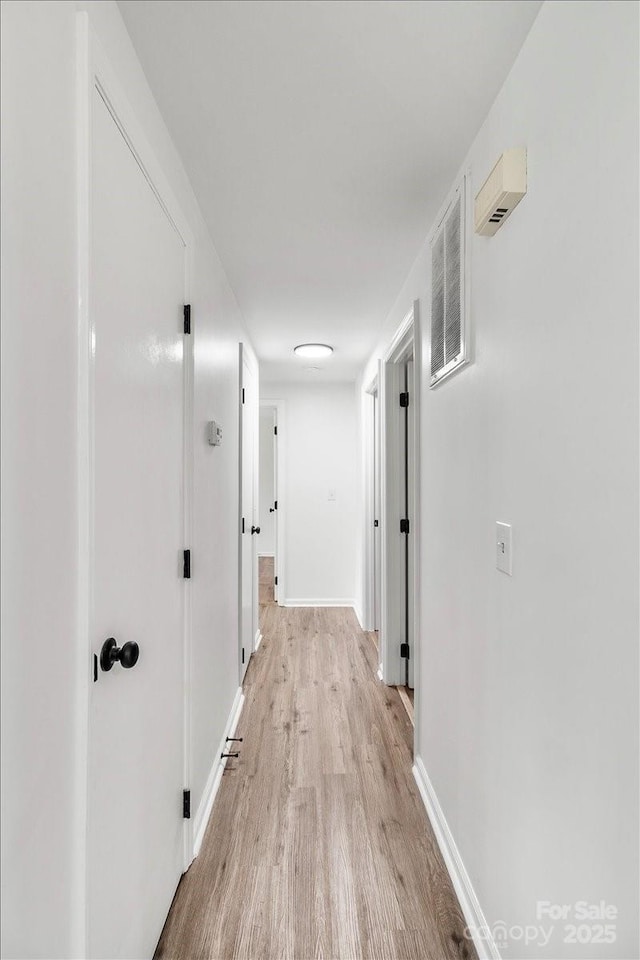 6839 Wagon Oak Rd, Charlotte, NC 28212 - hall featuring light wood-type flooring, visible vents, and baseboards
