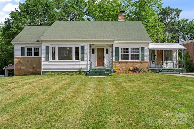view of front of home featuring a chimney, a front lawn, and stone siding