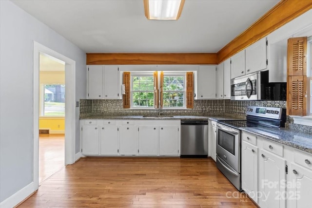 kitchen featuring a sink, white cabinetry, and stainless steel appliances