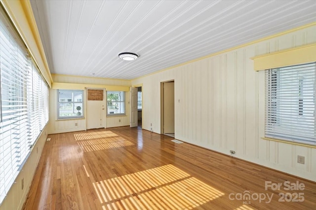 unfurnished living room featuring crown molding, wood finished floors, and visible vents