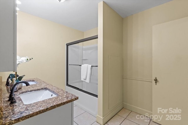 full bath with vanity, tile patterned floors, and combined bath / shower with glass door