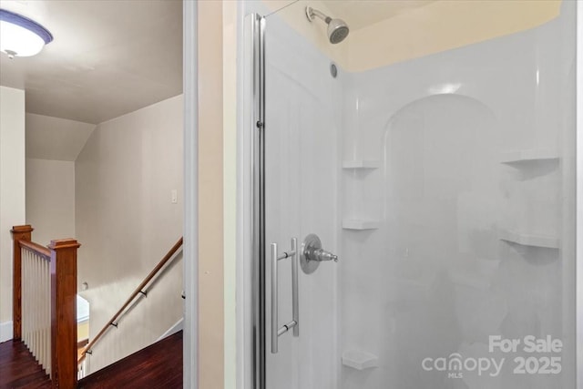 full bath with wood finished floors and a stall shower