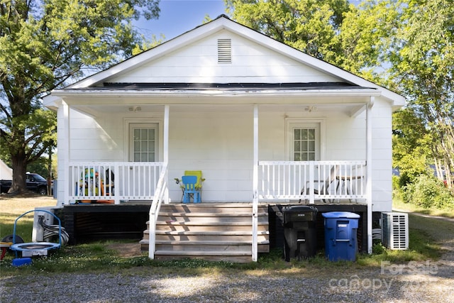 bungalow featuring covered porch and cooling unit