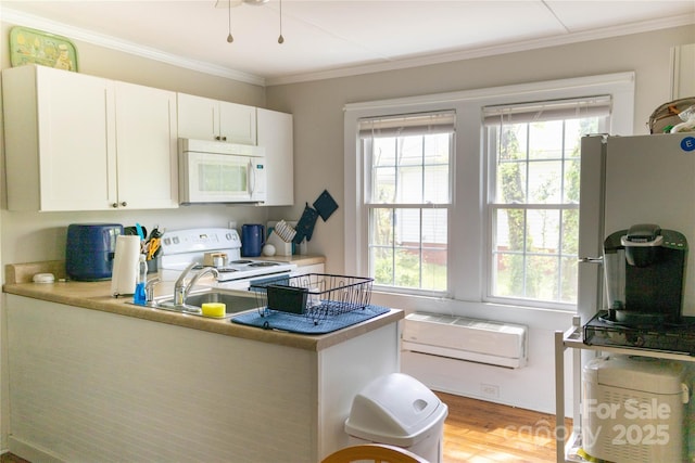 kitchen with plenty of natural light, white cabinetry, white appliances, and light wood-type flooring