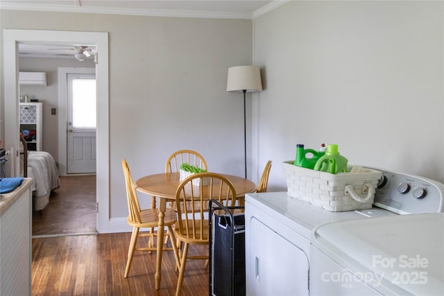 laundry area featuring ceiling fan, laundry area, independent washer and dryer, crown molding, and wood finished floors
