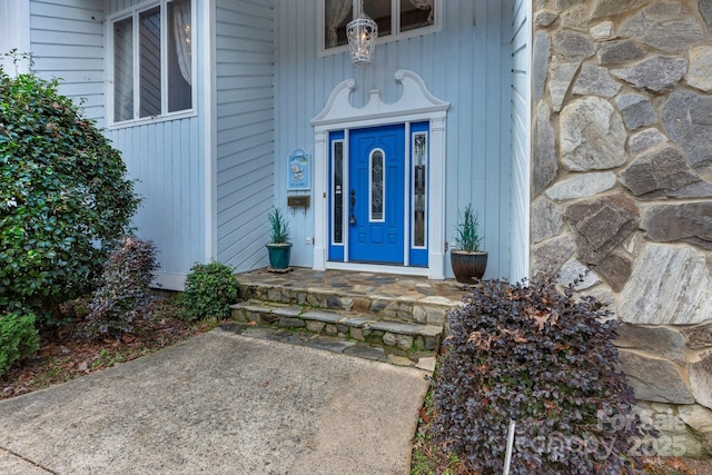 doorway to property featuring stone siding