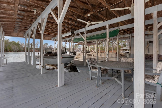 exterior space with a water view, a boat dock, and boat lift