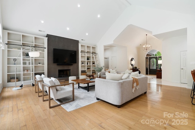 1245 Bellemeade Ln, Charlotte, NC 28270 - living area featuring high vaulted ceiling, light wood finished floors, a fireplace, recessed lighting, and a chandelier