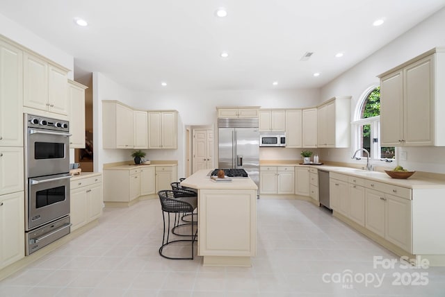 1245 Bellemeade Ln, Charlotte, NC 28270 - kitchen with stainless steel appliances, a sink, a warming drawer, a center island, and a breakfast bar