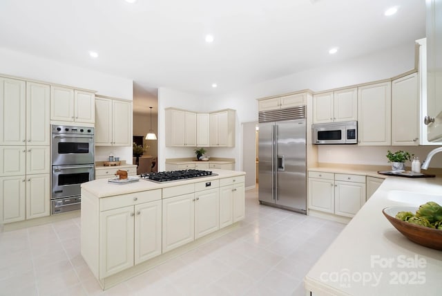1245 Bellemeade Ln, Charlotte, NC 28270 - kitchen featuring appliances with stainless steel finishes, a sink, a warming drawer, a kitchen island, and light countertops