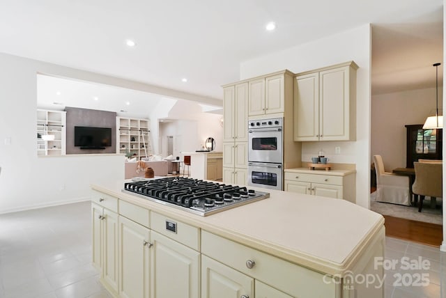 1245 Bellemeade Ln, Charlotte, NC 28270 - kitchen featuring cream cabinetry, appliances with stainless steel finishes, light countertops, a kitchen island, and open floor plan