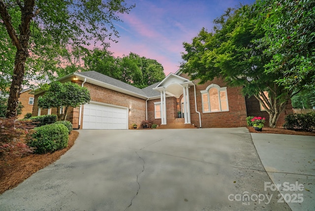 1245 Bellemeade Ln, Charlotte, NC 28270 - view of front facade featuring a garage, brick siding, and driveway