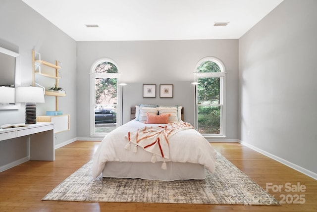 1245 Bellemeade Ln, Charlotte, NC 28270 - bedroom with multiple windows, light wood-type flooring, and baseboards