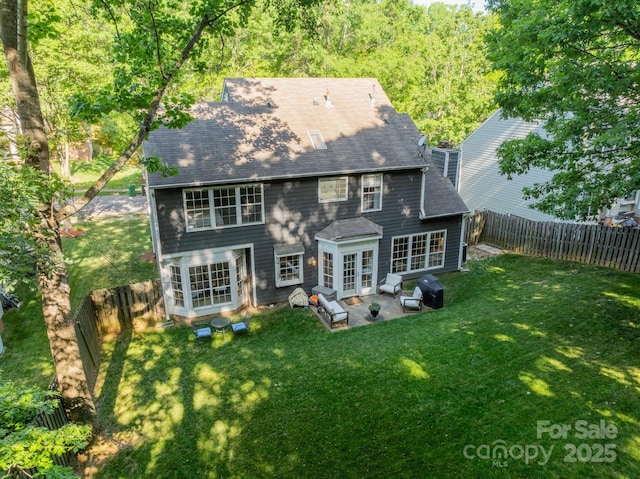 4201 Beauvista Dr, Charlotte, NC 28269 - rear view of house featuring a yard, a patio, a shingled roof, and a fenced backyard