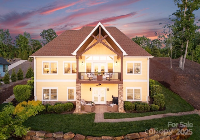 249 Landing Trl, Mount Gilead, NC 27306 - rear view of house featuring stone siding, an outdoor living space, a balcony, french doors, and a yard