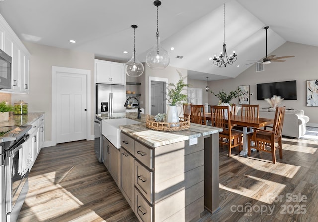 249 Landing Trl, Mount Gilead, NC 27306 - kitchen with white cabinets, a sink, ceiling fan with notable chandelier, stainless steel appliances, and lofted ceiling