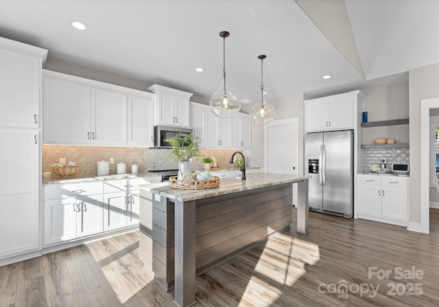 249 Landing Trl, Mount Gilead, NC 27306 - kitchen with appliances with stainless steel finishes, decorative backsplash, recessed lighting, and white cabinetry
