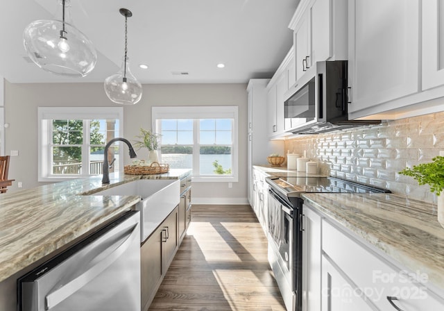 249 Landing Trl, Mount Gilead, NC 27306 - kitchen featuring decorative backsplash, light stone countertops, recessed lighting, a sink, and stainless steel appliances
