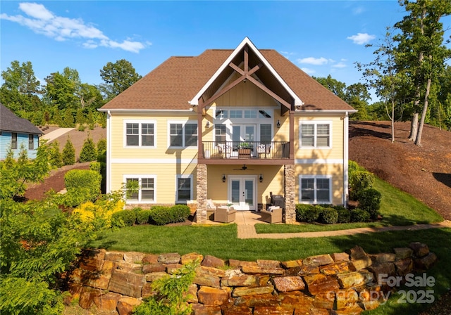 249 Landing Trl, Mount Gilead, NC 27306 - rear view of house with ceiling fan, an outdoor living space, french doors, a lawn, and stone siding