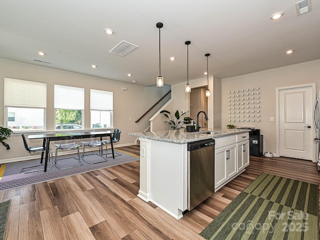 kitchen with dishwasher, baseboards, a sink, white cabinetry, and wood finished floors