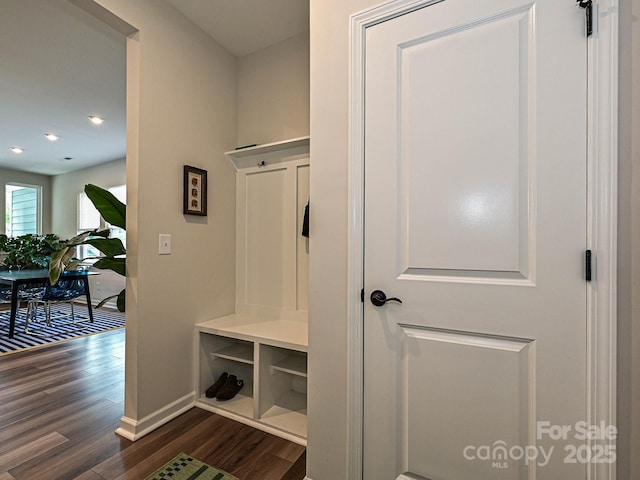 mudroom with dark wood-style flooring, baseboards, and recessed lighting