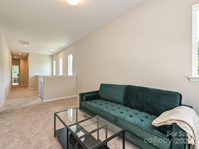 living room with baseboards, recessed lighting, light carpet, and visible vents