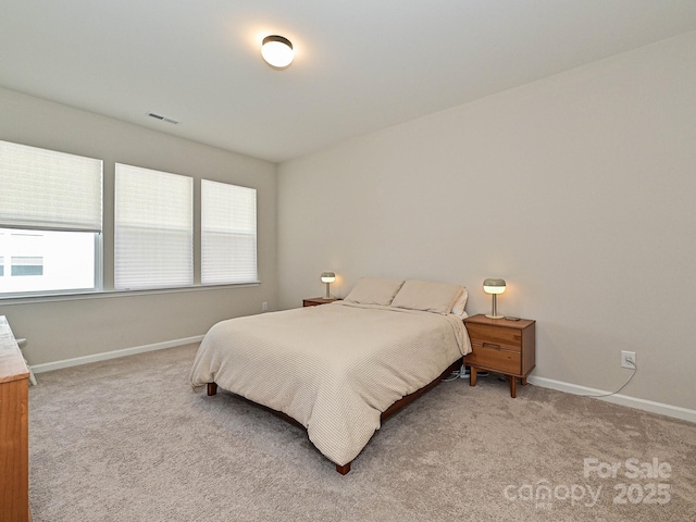bedroom with light carpet, baseboards, and visible vents