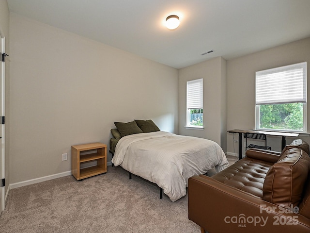 bedroom with carpet floors, baseboards, and visible vents