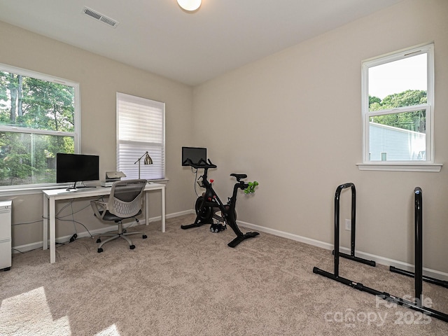 office area featuring baseboards, light carpet, and visible vents