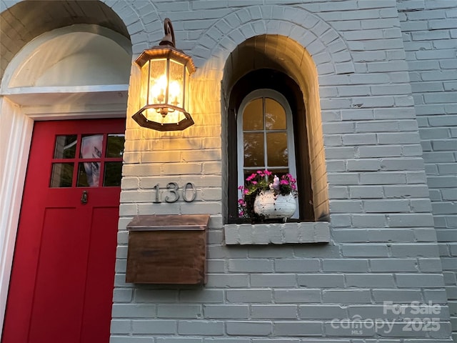 property entrance featuring brick siding