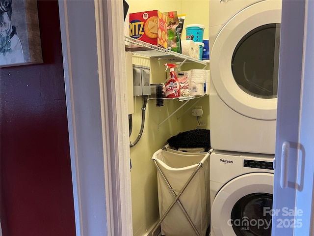 laundry room with stacked washer and dryer and laundry area